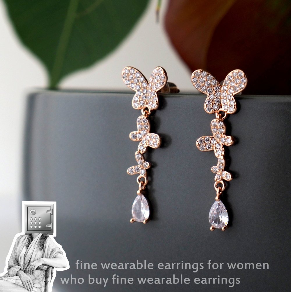 Elegant rose gold earrings featuring sparkling butterfly designs with dangling facets.
