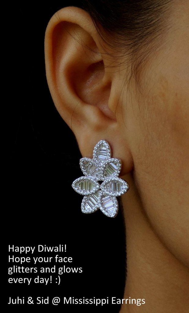 Close-up of a woman's ear wearing a floral-shaped earring, showcasing a sparkling design, with a greeting for Diwali in the background.